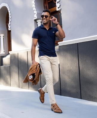 Navy Polo Outfits For Men: A navy polo and beige chinos paired together are a sartorial dream for those who love relaxed casual styles. To add a bit of classiness to your getup, add brown leather double monks.