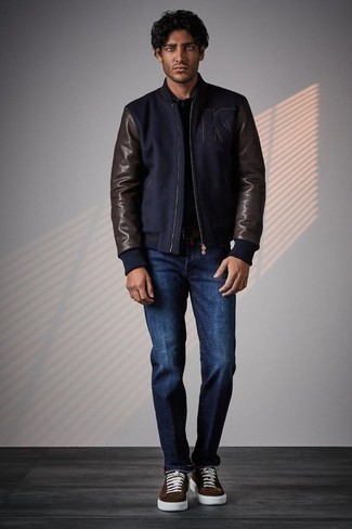 Men's Outfits 2022: A navy wool bomber jacket and navy jeans paired together are the ideal outfit for those dressers who appreciate casually cool styles. Dark brown suede low top sneakers are a welcome accompaniment for your outfit.