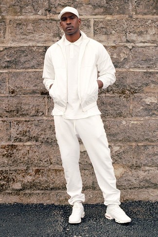 Skepta wearing White Bomber Jacket, White Polo, White Sweatpants, White Athletic Shoes