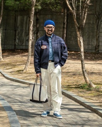 Tote Bag Outfits For Men: For a modern casual ensemble, Dress in a navy embroidered bomber jacket and a tote bag. Give a different twist to an otherwise standard outfit by sporting blue canvas low top sneakers.