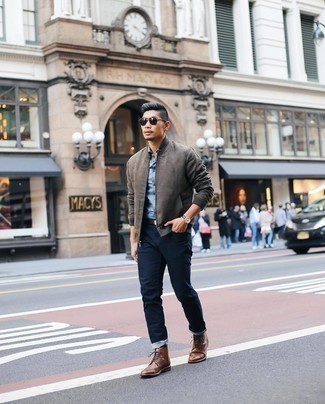 Charcoal Bomber Jacket Outfits For Men: Extra stylish and practical, this off-duty combo of a charcoal bomber jacket and navy jeans will provide you with variety. Introduce a pair of brown leather brogue boots to this getup for a masculine aesthetic.