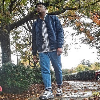 Men's Navy Bomber Jacket, White and Navy Vertical Striped Short Sleeve Shirt, Blue Jeans, White and Black Athletic Shoes