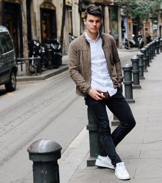 White and Green Leather Low Top Sneakers Outfits For Men: Such pieces as a brown suede bomber jacket and black jeans are the perfect way to inject toned down dapperness into your casual arsenal. Add a pair of white and green leather low top sneakers to the mix and ta-da: your look is complete.