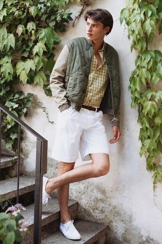 White Shorts Outfits For Men: An olive quilted bomber jacket looks especially nice when paired with white shorts in a casual menswear style. A pair of white canvas low top sneakers can integrate smoothly within a ton of outfits.