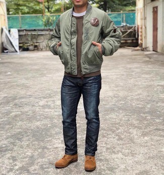 Olive Bomber Jacket Outfits For Men: An olive bomber jacket and navy jeans are a great pairing to add to your casual rotation. A trendy pair of tobacco suede casual boots is an effortless way to inject an extra dose of style into this outfit.