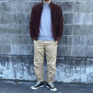 Chinos Outfits In Their 30s: Who said you can't make a fashionable statement with a casual outfit? You can do that efforlessly in a dark brown bomber jacket and chinos. Add a pair of black and white canvas low top sneakers to the equation to make a mostly classic outfit feel suddenly fresh. Laid-back getups for 30-something gentlemen aren't actually that hard, as you can see.