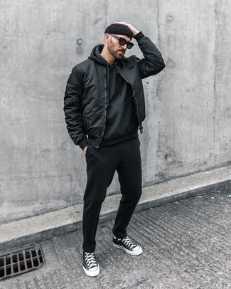 Black Bomber Jacket Outfits For Men: Make a black bomber jacket and a black track suit your outfit choice for comfort dressing with a street style finish. For maximum style effect, complete your outfit with a pair of black and white canvas high top sneakers.