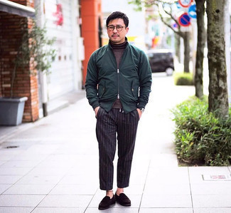 Dark Green Bomber Jacket Outfits For Men: Wear a dark green bomber jacket and black vertical striped chinos for both seriously stylish and easy-to-wear getup. Make your getup a bit classier by finishing with a pair of dark brown suede loafers.