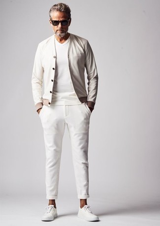 White and Blue Bomber Jacket Outfits For Men: This is solid proof that a white and blue bomber jacket and white chinos are awesome when paired together in an off-duty look. For something more on the casual side to finish off this outfit, complete your outfit with white canvas low top sneakers.