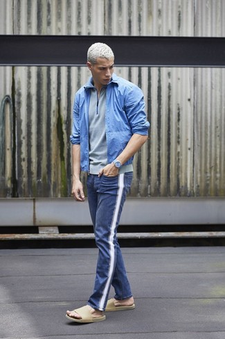 Blue Bomber Jacket Outfits For Men: To pull together an off-duty getup with a modernized spin, dress in a blue bomber jacket and blue jeans. A pair of beige leather sandals effortlessly ramps up the cool of this look.