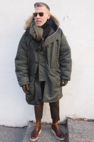 Nick Wooster wearing Olive Wool Scarf, Dark Brown Leather Brogue Boots, Dark Brown Wool Dress Pants, Olive Parka