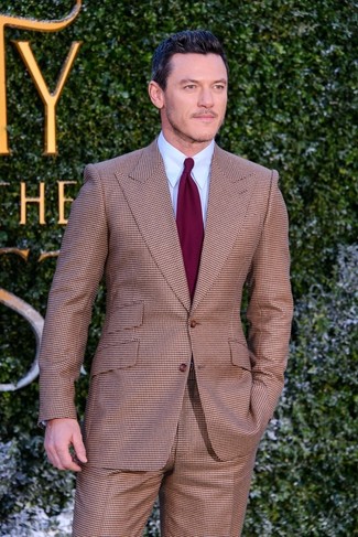 Luke Evans wearing Brown Check Suit, Light Blue Dress Shirt, Burgundy Tie