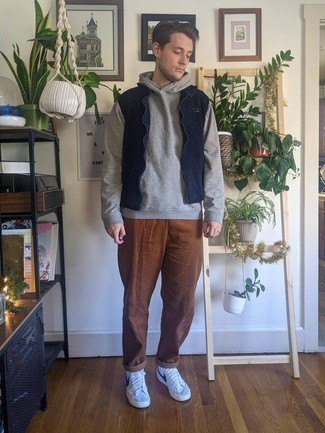 Men's White and Navy Leather High Top Sneakers, Brown Corduroy Chinos, Grey Hoodie, Navy Fleece Gilet