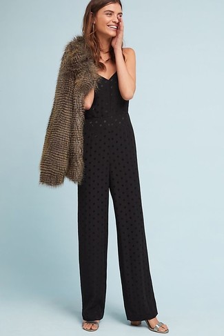 Fur Jacket Outfits: Consider teaming a fur jacket with a black eyelet jumpsuit to assemble an interesting and modern-looking laid-back ensemble. Serve a little outfit-mixing magic by rocking a pair of silver leather heeled sandals.