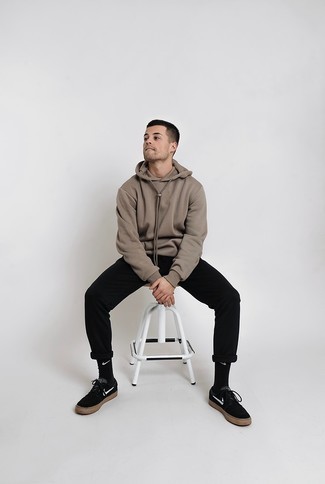 Dark Brown Hoodie Outfits For Men: This combo of a dark brown hoodie and black chinos is hard proof that a safe casual look doesn't have to be boring. If you're on the fence about how to finish, add a pair of black and white canvas low top sneakers to the equation.