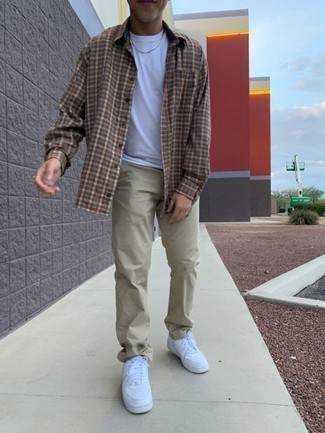 Brown Plaid Long Sleeve Shirt Outfits For Men: Who said you can't make a fashionable statement with a laid-back ensemble? That's easy in a brown plaid long sleeve shirt and beige chinos. Look at how nice this getup is finished off with a pair of white leather low top sneakers.