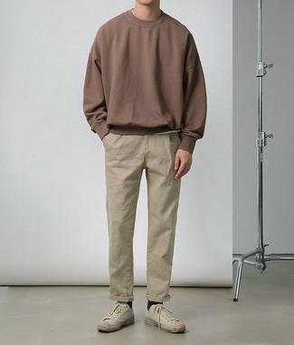 Dark Brown Sweatshirt Outfits For Men: This off-duty combo of a dark brown sweatshirt and beige chinos is a goofproof option when you need to look neat and relaxed but have zero time. Add beige canvas low top sneakers to the equation and you're all done and looking boss.