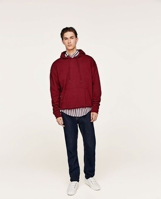 Burgundy Hoodie Outfits For Men: The combo of a burgundy hoodie and navy jeans makes this a solid casual look. A pair of white canvas low top sneakers looks perfect here.