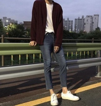 Red Cardigan Relaxed Outfits For Men: We're all hunting for functionality when it comes to style, and this bold casual pairing of a red cardigan and navy ripped jeans is a great illustration of that. As for footwear, complete your look with white canvas low top sneakers.