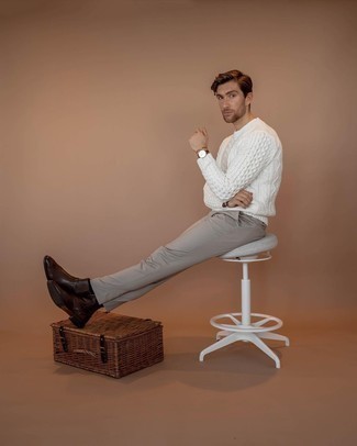 White Cable Sweater Outfits For Men: If you're on the lookout for a relaxed yet seriously stylish ensemble, consider wearing a white cable sweater and beige chinos. A pair of dark brown leather chelsea boots instantly amps up the style factor of your look.