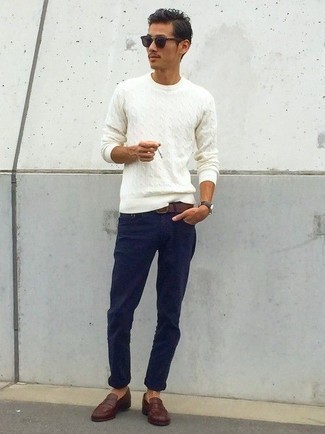 White Cable Sweater Outfits For Men: When the situation permits a casual outfit, opt for a white cable sweater and navy chinos. Dark brown leather loafers are the most effective way to power up your ensemble.