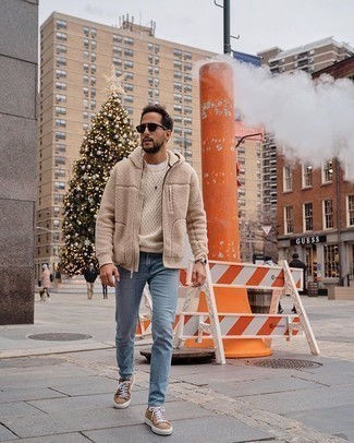 Beige Fleece Hoodie Outfits For Men: A beige fleece hoodie and light blue jeans are the perfect base for a cool and casual getup. On the footwear front, this look pairs perfectly with tan canvas low top sneakers.