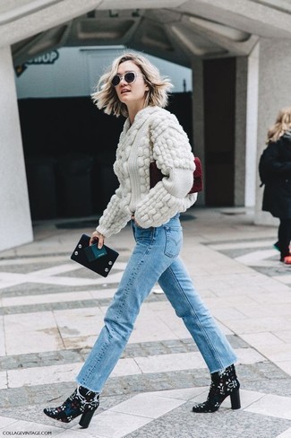Beige Cable Sweater Outfits For Women: Consider pairing a beige cable sweater with light blue jeans if you seek to look casually cool without much effort. Bring a glamorous twist to an otherwise mostly dressed-down outfit by finishing off with a pair of black print suede ankle boots.
