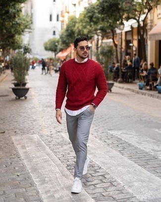 Red Cable Sweater Outfits For Men: This laid-back pairing of a red cable sweater and grey chinos can take on different forms according to how you style it. Puzzled as to how to round off? Complete this outfit with white canvas low top sneakers to jazz things up.