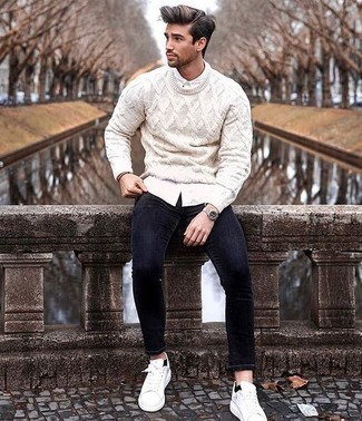 White Cable Sweater Outfits For Men: Choose a white cable sweater and black skinny jeans for a edgy and casual and trendy ensemble. White leather low top sneakers act as the glue that will bring your ensemble together.