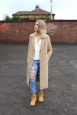 Camel Coat Outfits For Women: Go for a straightforward yet casually stylish ensemble in a camel coat and blue ripped boyfriend jeans. Introduce a pair of tan nubuck lace-up flat boots to the mix et voila, the look is complete.