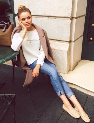Driving Shoes Outfits For Women: If you're on the lookout for a casual but also incredibly chic getup, dress in a camel coat and blue skinny jeans. Let your outfit coordination skills truly shine by complementing this look with a pair of driving shoes.