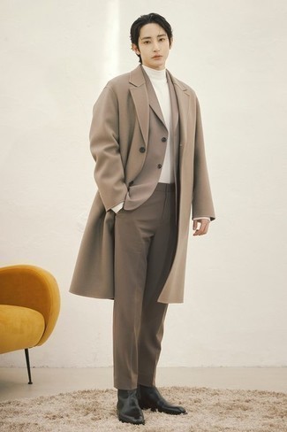 Tan Suit Outfits: A tan suit looks so elegant when teamed with a camel overcoat for a look worthy of a proper gent. Rev up this outfit by slipping into black leather chelsea boots.