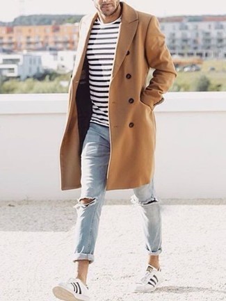 White and Black Leather Low Top Sneakers Outfits For Men: If you're looking for a relaxed casual yet dapper outfit, consider teaming a camel overcoat with light blue ripped jeans. White and black leather low top sneakers tie the look together.