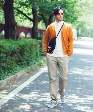 500+ Spring Outfits For Men: This relaxed pairing of an orange cardigan and beige chinos will attract attention for all the right reasons. Bring a bit more edginess to with grey canvas low top sneakers. This outfit is a great choice when spring arrives.