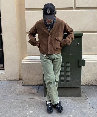 Men's Outfits 2022: You're looking at the undeniable proof that a brown knit cardigan and olive chinos look amazing when worn together in a laid-back ensemble. Complement your look with a pair of black chunky leather loafers for a sense of class.