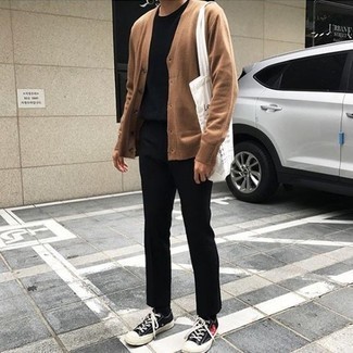 Tan Cardigan Outfits For Men: A tan cardigan and black chinos are an easy way to introduce subtle dapperness into your current styling lineup. A pair of black print canvas low top sneakers will bring a mellow vibe to this outfit.