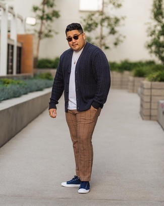 Navy Canvas Low Top Sneakers Outfits For Men: Inject new life into your daily off-duty wardrobe with a navy knit cardigan and brown check chinos. Complete this outfit with a pair of navy canvas low top sneakers and the whole getup will come together.