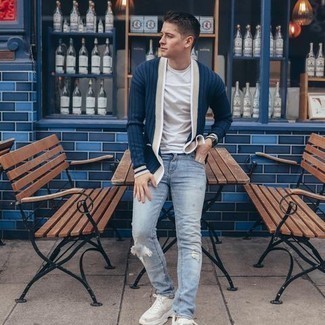 Navy Cardigan Outfits For Men: If you feel more confident wearing something practical, you'll appreciate this modern casual pairing of a navy cardigan and light blue ripped jeans. Introduce a pair of beige athletic shoes to this outfit to infuse a dose of stylish casualness into your outfit.