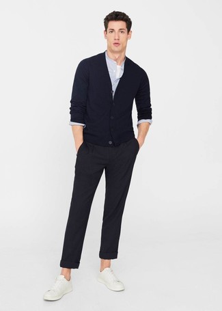 A navy cardigan and black chinos are wonderful menswear must-haves that will integrate well within your casual collection. White leather low top sneakers are guaranteed to bring a touch of stylish effortlessness to this look.