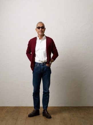 A burgundy cardigan and navy jeans are essential in any gent's functional casual sartorial arsenal. A pair of burgundy leather desert boots will be the ideal complement to your look.
