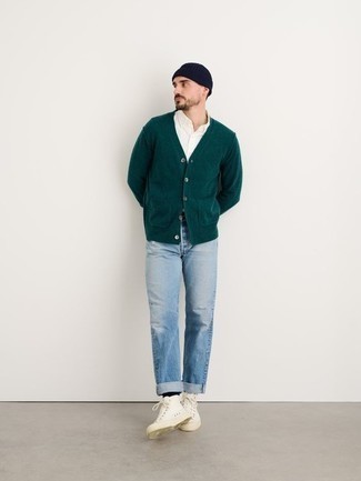 500+ Spring Outfits For Men: For relaxed dressing with a clear fashion twist, consider wearing a dark green cardigan and light blue jeans. If you wish to easily dial down this getup with a pair of shoes, why not add a pair of white canvas high top sneakers to your outfit? This ensemble is our idea of perfection for those comfortable springtime days.