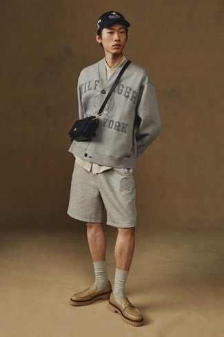 Sports Shorts Outfits For Men: If you're on the hunt for a laid-back but also seriously stylish look, choose a grey embroidered cardigan and sports shorts. Wondering how to finish your outfit? Wear a pair of tan leather loafers to kick it up a notch.