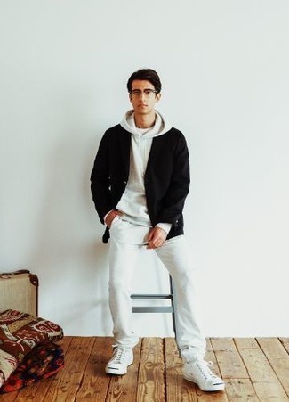 White Canvas Low Top Sneakers Outfits For Men: If you like stay-in clothes which are stylish enough to wear out, you should consider this pairing of a black cardigan and a white track suit. On the footwear front, this ensemble is completed perfectly with white canvas low top sneakers.