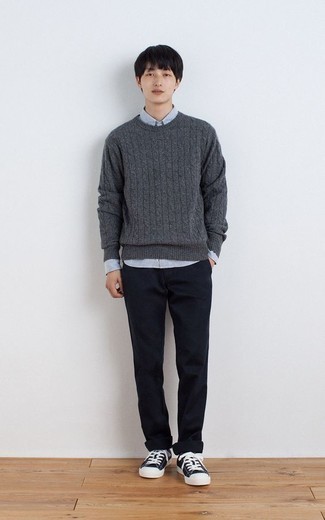 Charcoal Cable Sweater Outfits For Men: A charcoal cable sweater and navy chinos are a cool ensemble to add to your current off-duty lineup. Our favorite of an infinite number of ways to complement this outfit is a pair of navy and white canvas low top sneakers.