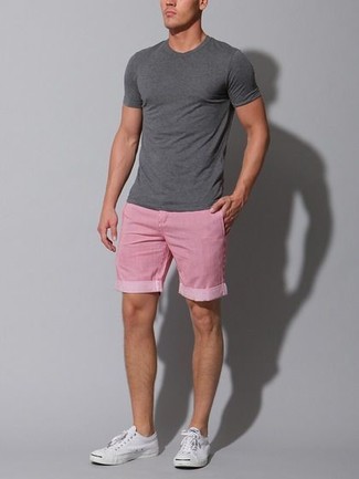 Hot Pink Shorts Outfits For Men: Go for a charcoal crew-neck t-shirt and hot pink shorts for an off-duty ensemble with a modern take. Showcase your refined side by finishing with white plimsolls.
