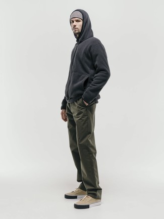 Tan Canvas Low Top Sneakers Outfits For Men: For an ensemble that's very straightforward but can be styled in a variety of different ways, consider wearing a charcoal fleece hoodie and olive chinos. Introduce tan canvas low top sneakers to the equation and you're all set looking killer.