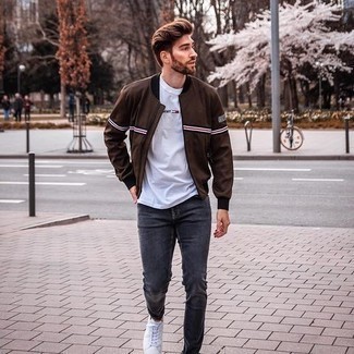 Men's White Canvas Low Top Sneakers, Charcoal Jeans, White Print Crew-neck T-shirt, Dark Brown Print Bomber Jacket