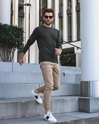 Grey Long Sleeve T-Shirt Outfits For Men: A grey long sleeve t-shirt and khaki chinos are the kind of a foolproof casual look that you need when you have no extra time to spare. White and black leather low top sneakers serve as the glue that will bring your getup together.
