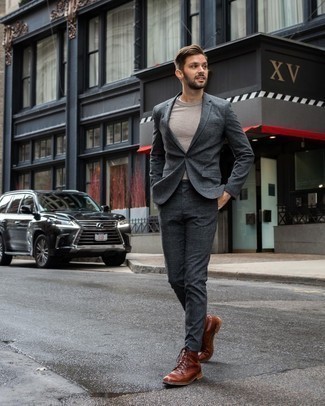 Charcoal Plaid Suit Outfits: You'll be surprised at how super easy it is for any man to pull together this effortlessly refined outfit. Just a charcoal plaid suit and a beige crew-neck sweater. Complement your ensemble with brown leather casual boots to immediately boost the cool of this outfit.