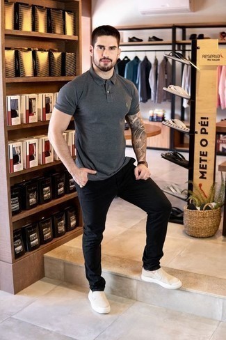 1200+ Hot Weather Outfits For Men: This combo of a charcoal polo and black chinos is proof that a safe casual ensemble can still be really interesting. Beige canvas slip-on sneakers pull the outfit together.